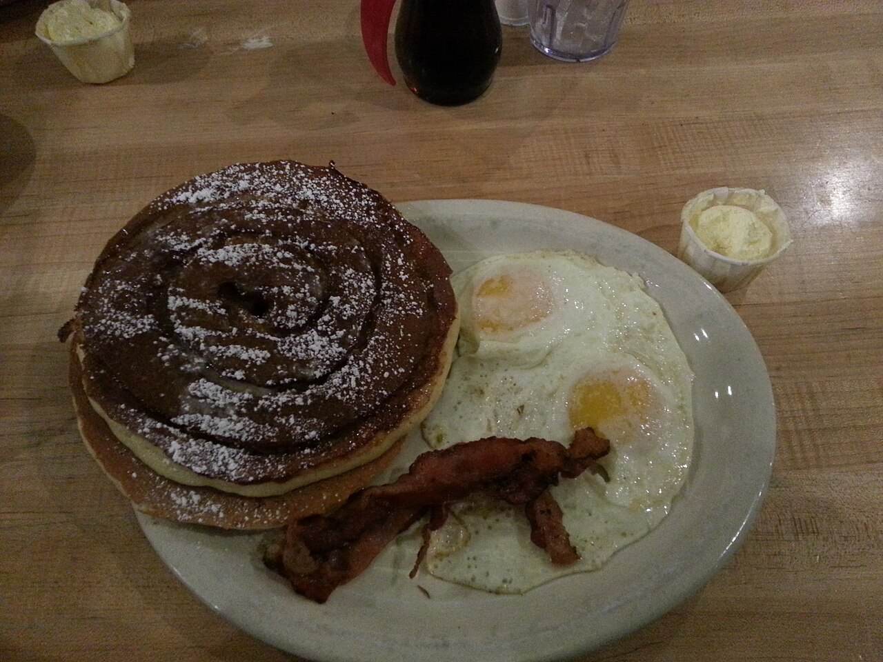A plate of pancakes, bacon and eggs