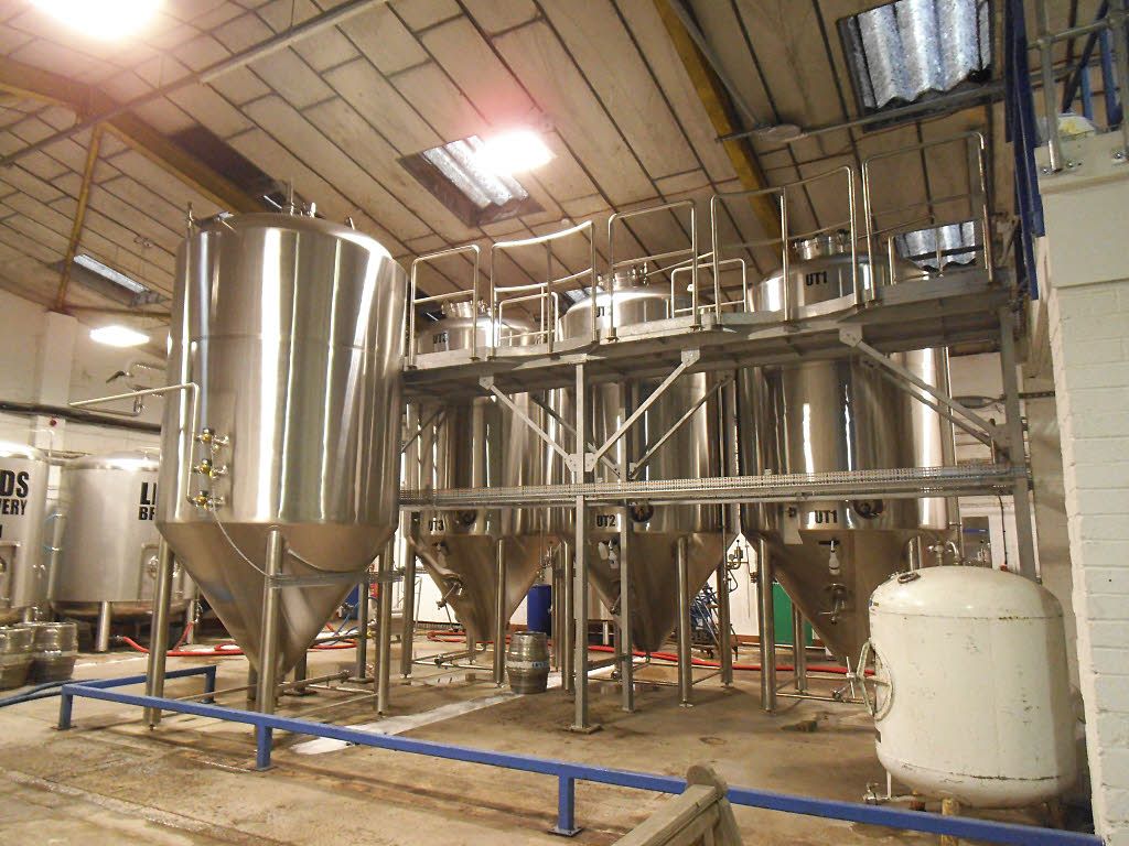 Steel fermentation tanks inside a brewery