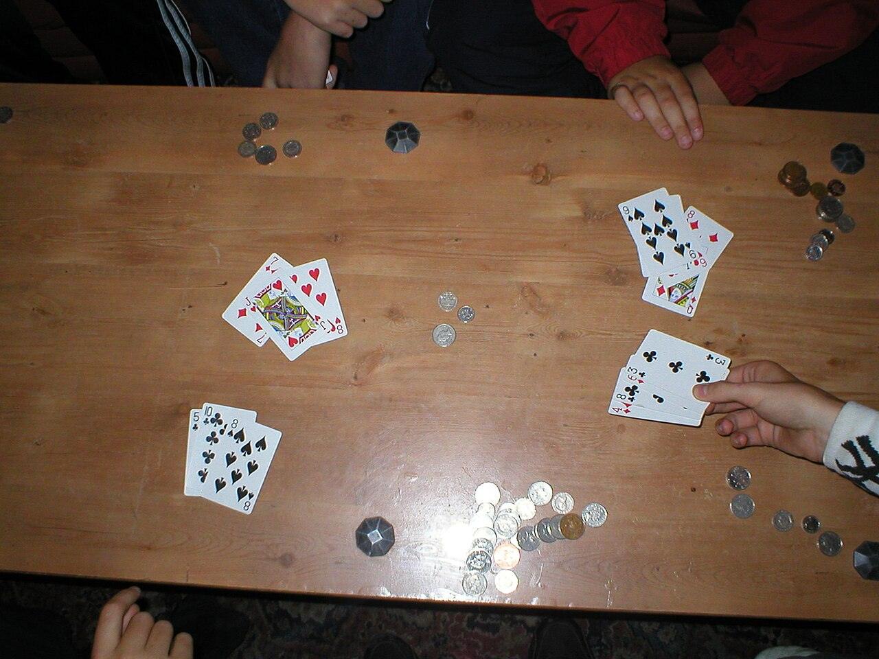Playing cards and chips on a table, seen from above