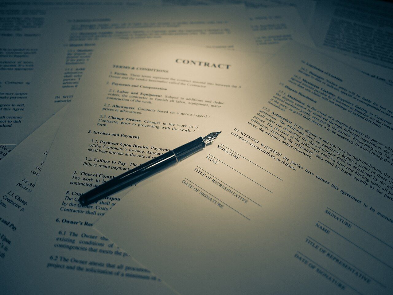 A contract and a pen on a desk