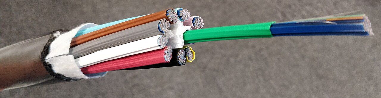 The colored fibers inside a cut fiber optic cable
