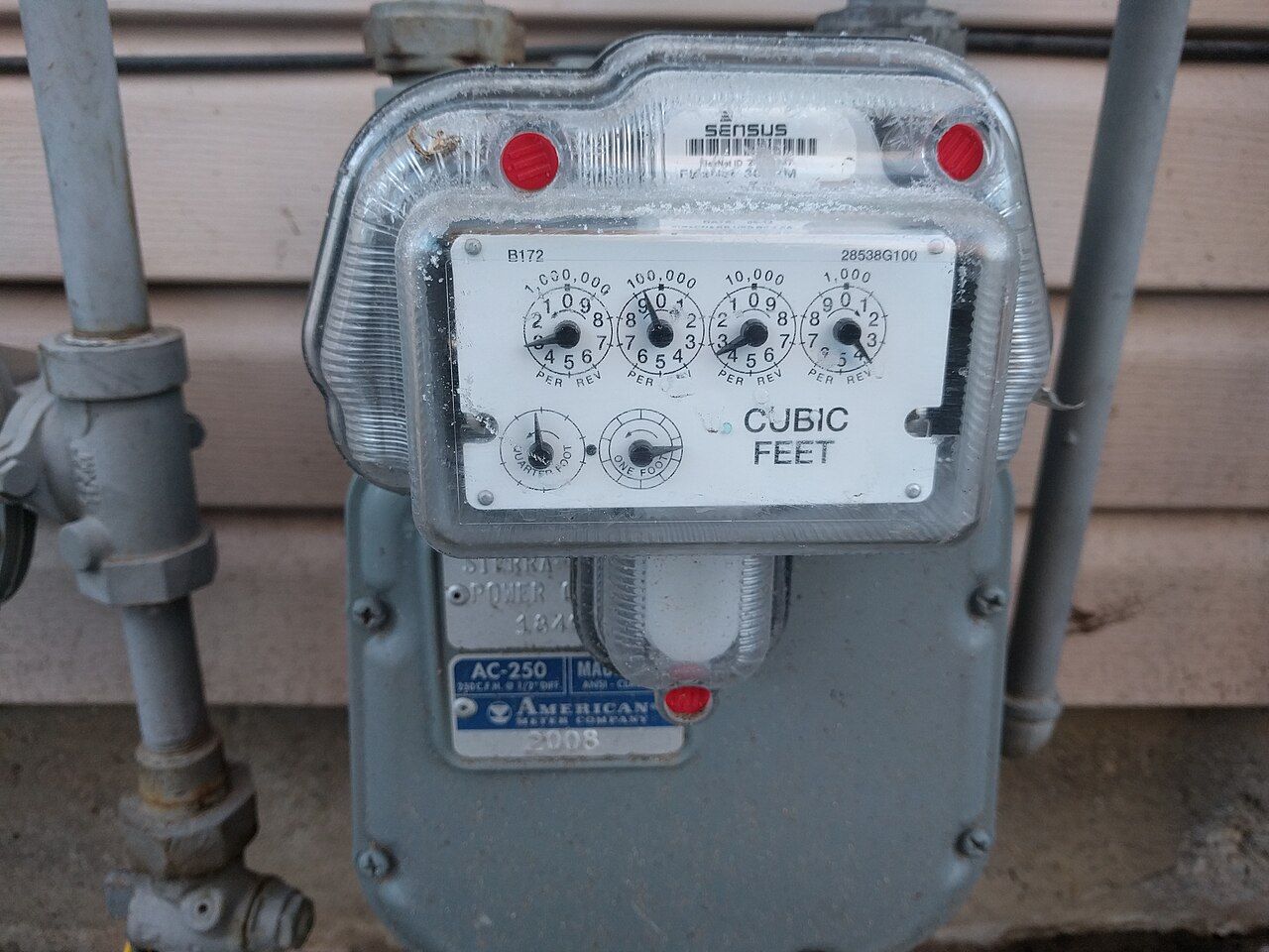 A natural gas meter on the side of a house