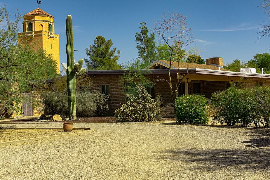 A southwest-style house with cactus in the yard