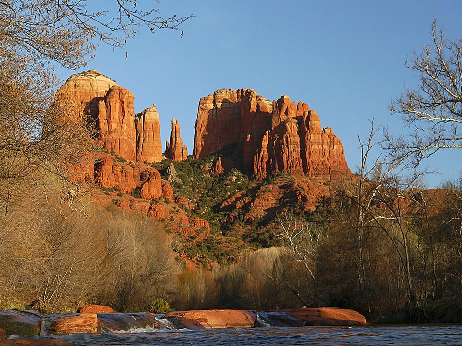 Cathedral Rock in Sedona, red rock spires above trees