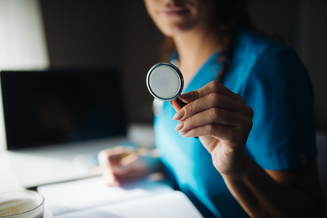 A doctor holding up a stethoscope