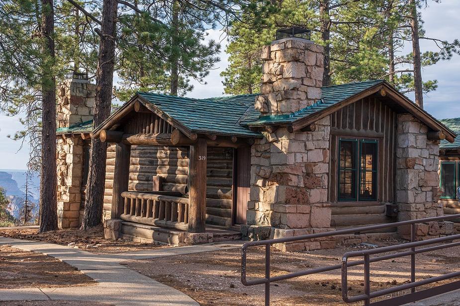 A stone and log cabin among pines